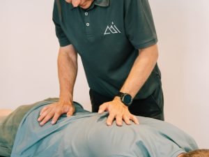 Physiotherapist providing manual therapy treatment for lower back pain at Peak Performance Institute Perth