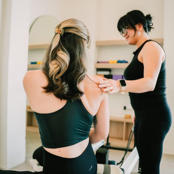 Pilates instructor leading reformer Pilates session at Peak Performance Institute West Leederville Perth