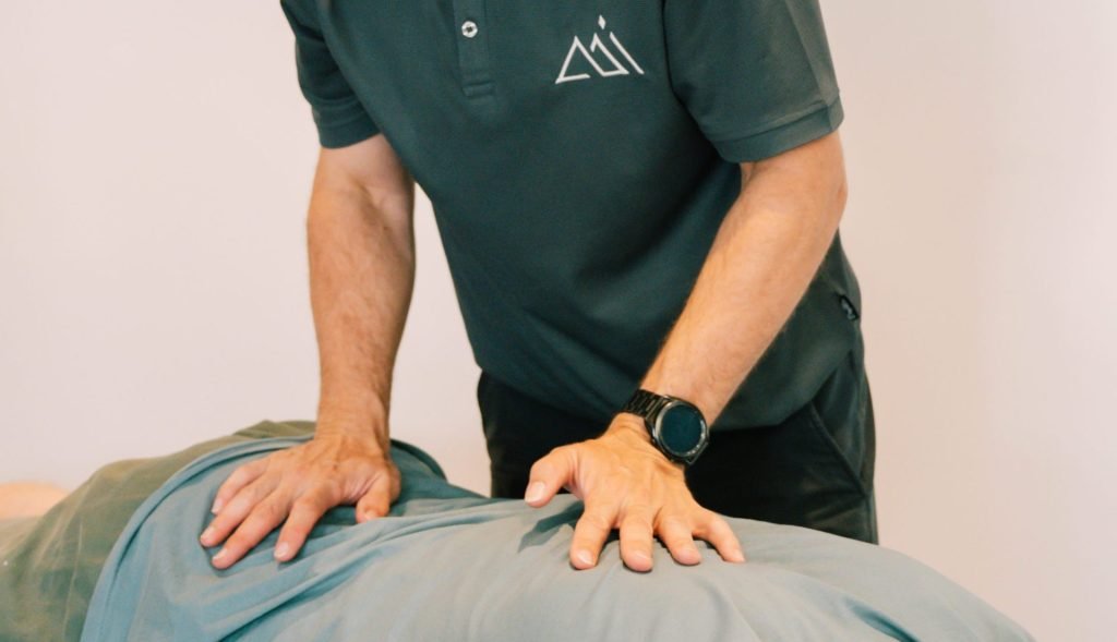 Physiotherapist providing manual therapy treatment for lower back pain at Peak Performance Institute Perth