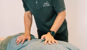Physiotherapist providing manual therapy treatment for lower back pain at Peak Performance Institute Perth